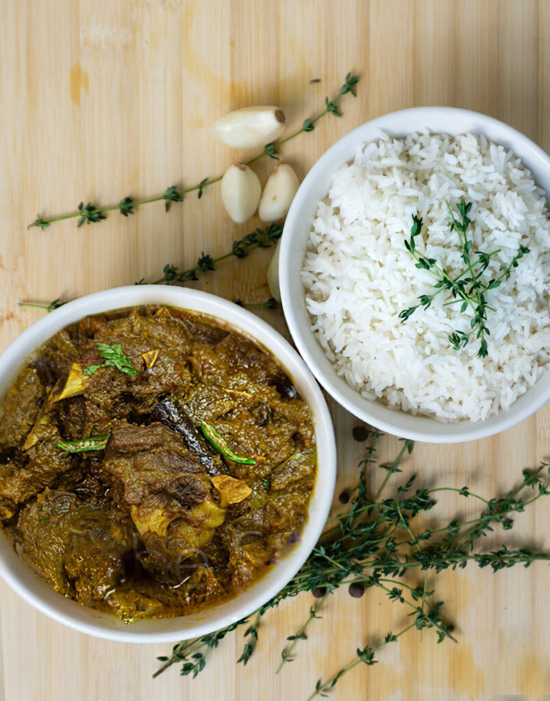 https://jamaicandutchpotny.com/wp-content/uploads/2023/02/curried-goat-and-whitw-rice-803x1024.jpg